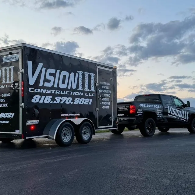 Black Vision III Construction truck and enclosed trailer with the business name and phone number